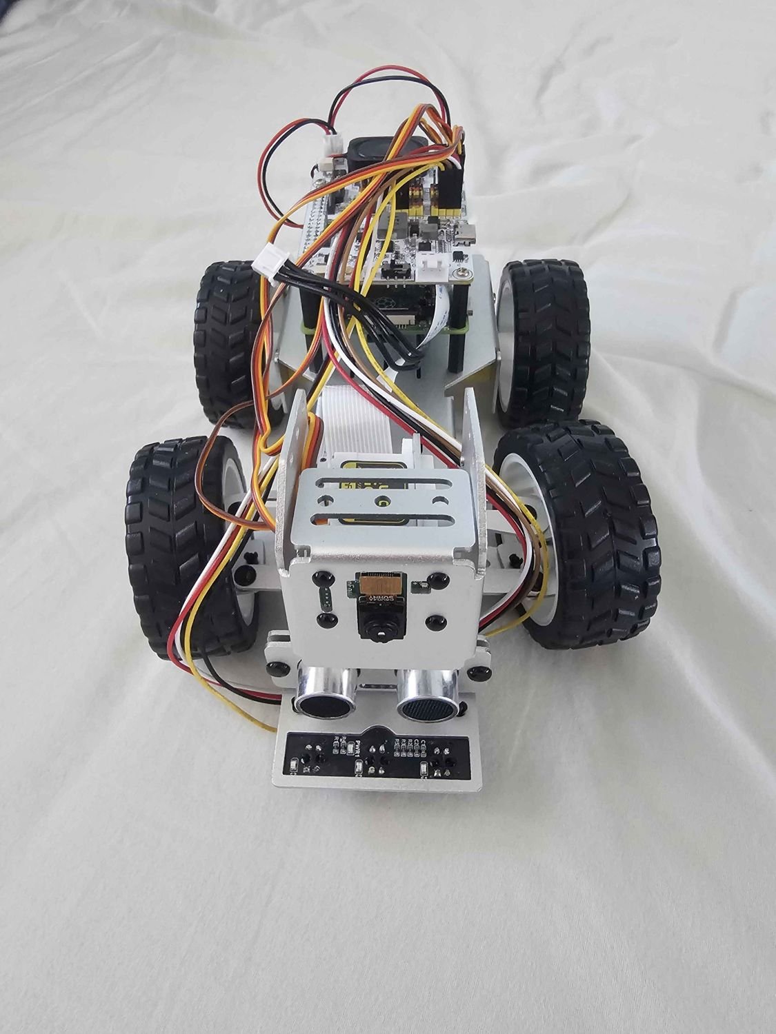 RC car top-down view showing wiring, camera mount, and sensor array