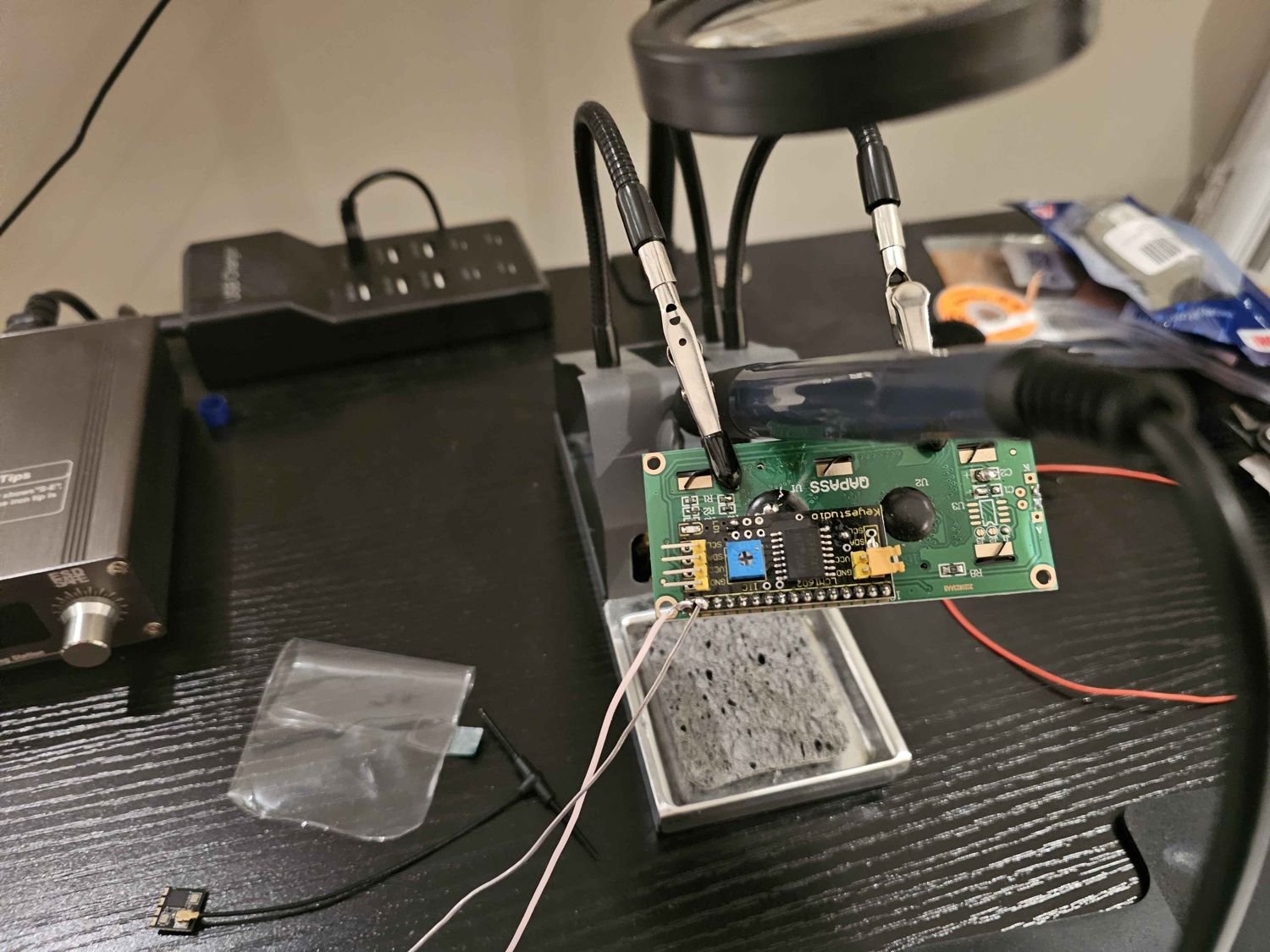 Soldering an LCD display board at the workbench